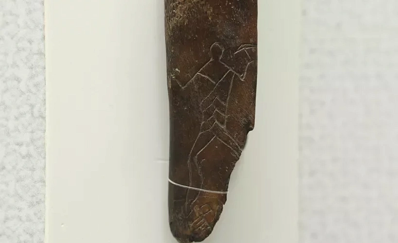 Костка з малюнкам «паляўнічы з сякерай» з паселішча каля вёскі Азярное Любанскага раёна